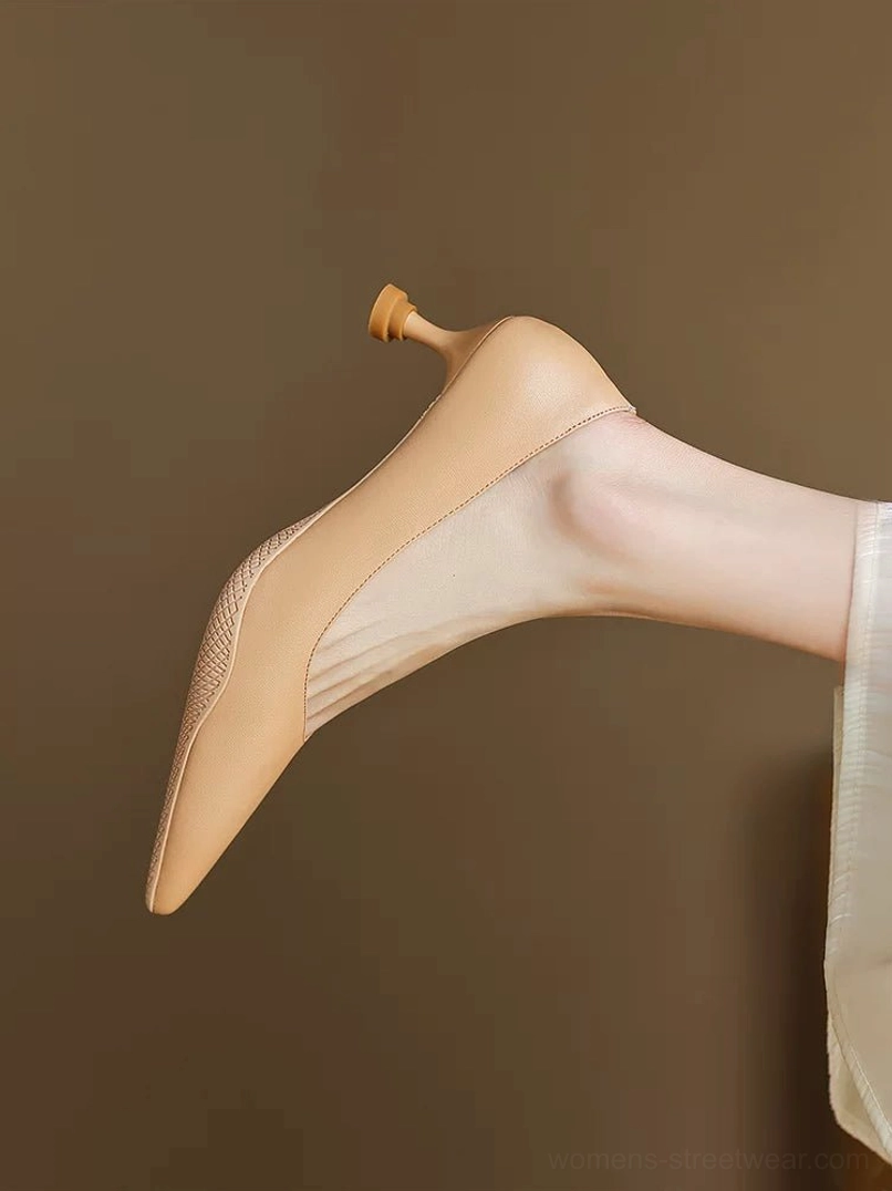 Nude soft leather pointed-toe kitten heel pumps with mesh vamp panel shown in a low side close-up