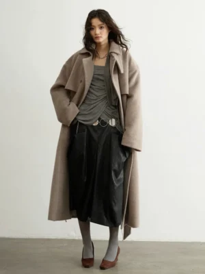 Oatmeal double-breasted oversized wool blend trench coat flat lay showing matching belt and front pockets