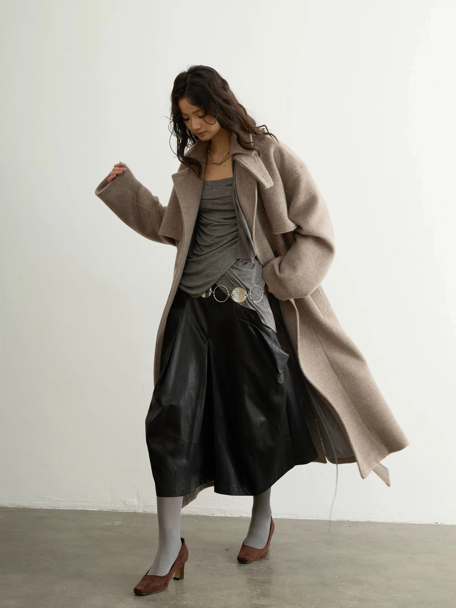 Side three-quarter view of oatmeal oversized wool blend trench coat with relaxed open fit and long hem