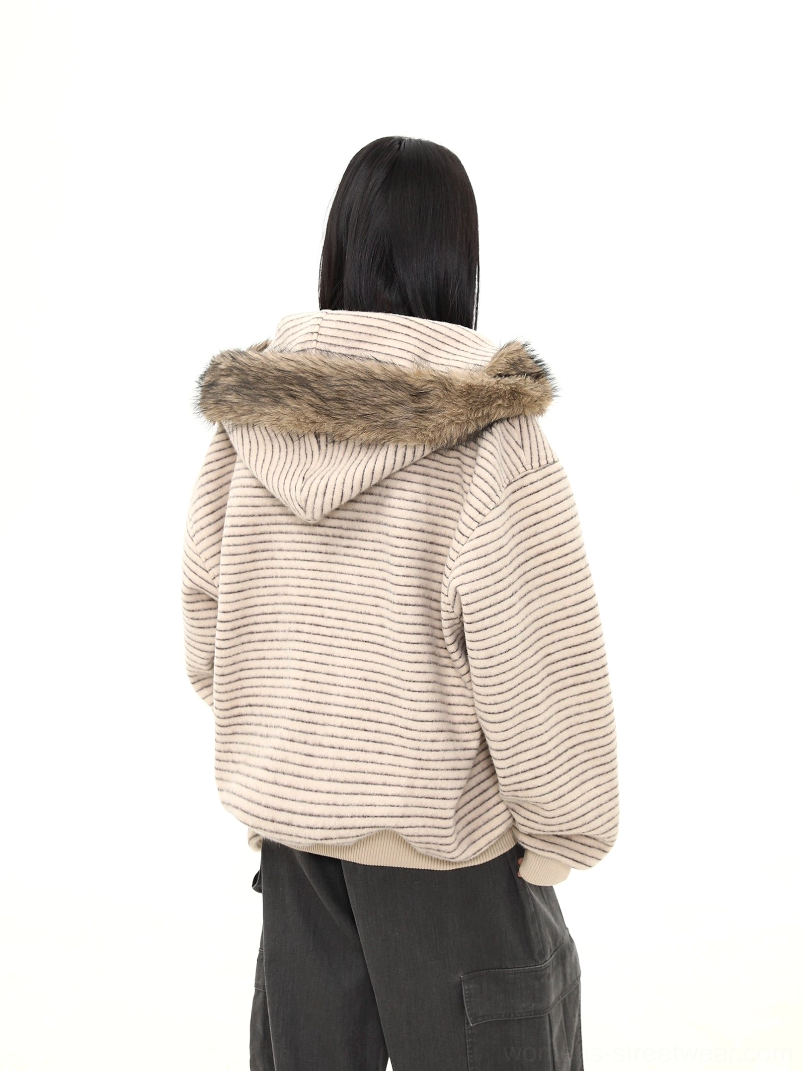Back view of an oatmeal striped faux fur hooded jacket showing horizontal texture ribbed hem cuffs and brown fur trim