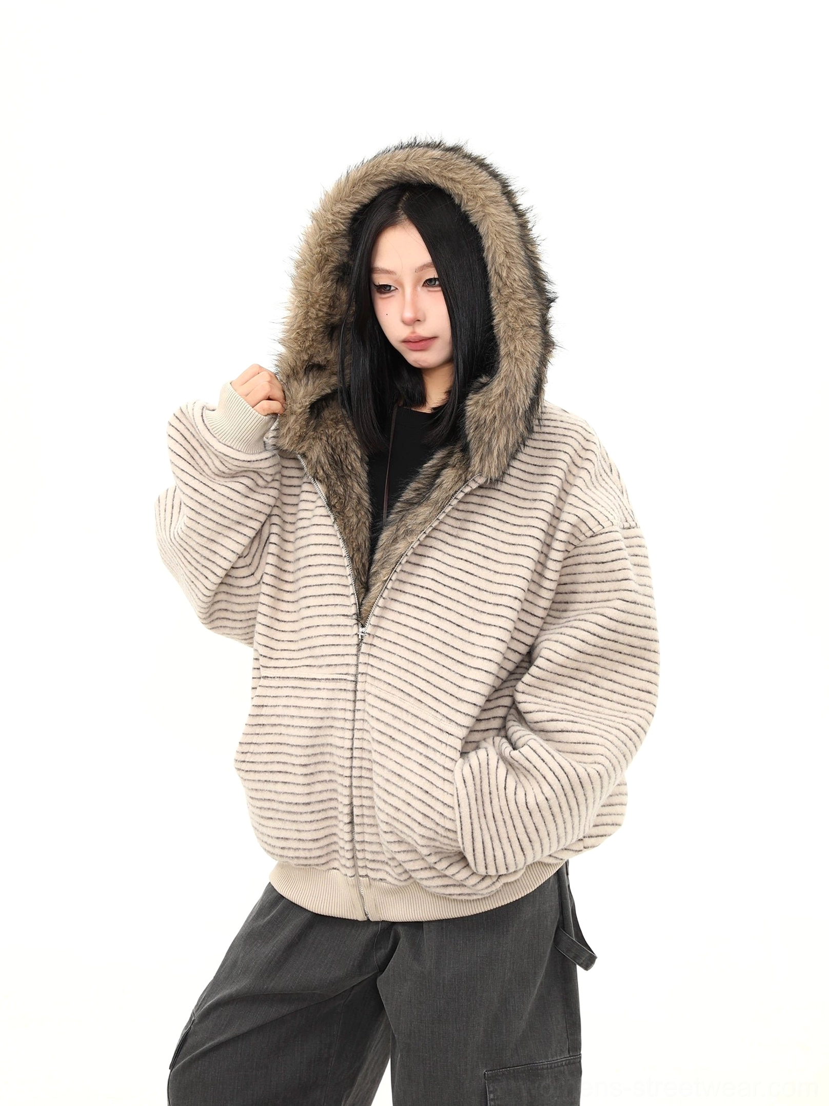 Oatmeal striped faux fur hooded jacket worn with the hood up to show the warm shaggy brown fur trim