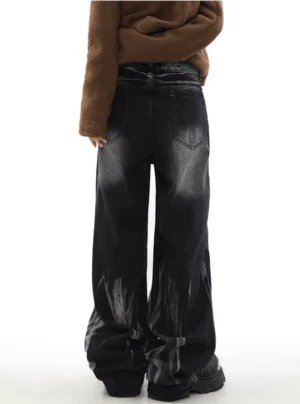 Back full-body view of washed black wide-leg denim jeans showing classic back pockets faded hem details and relaxed streetwear fit