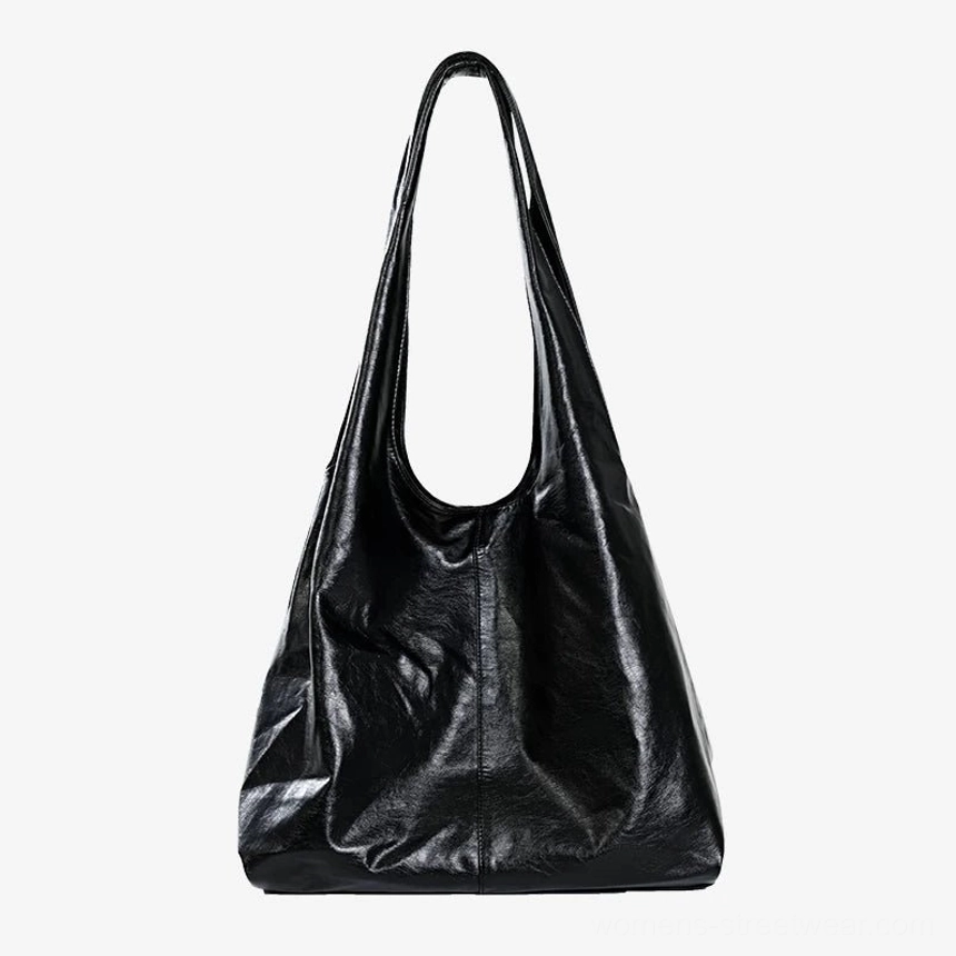 Black Obsidian glossy slouch hobo tote bag with oversized sculptural silhouette and shoulder strap