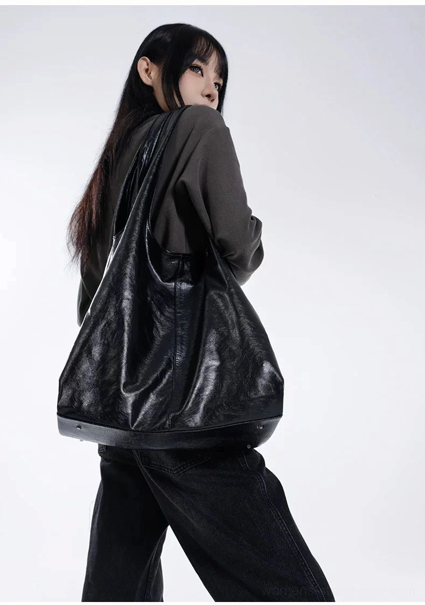 Oversized black slouch hobo tote bag back view showing roomy soft body and shoulder strap