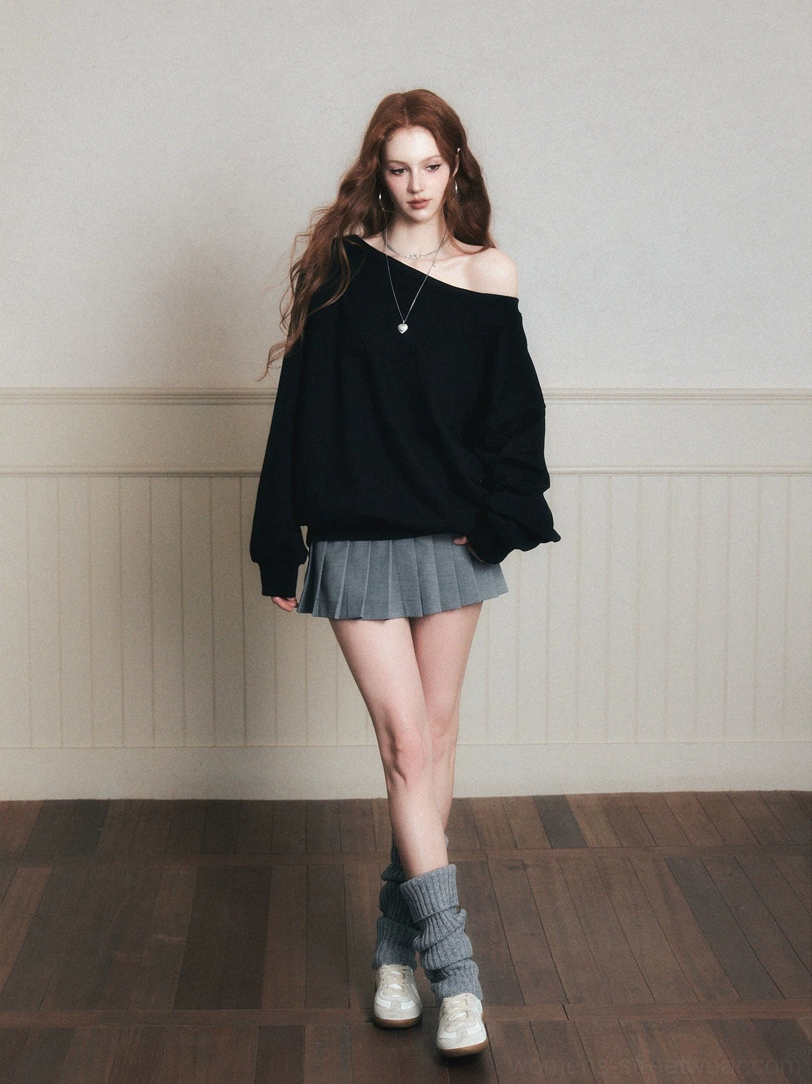 Black off-shoulder oversized campus sweatshirt styled with gray pleated mini skirt