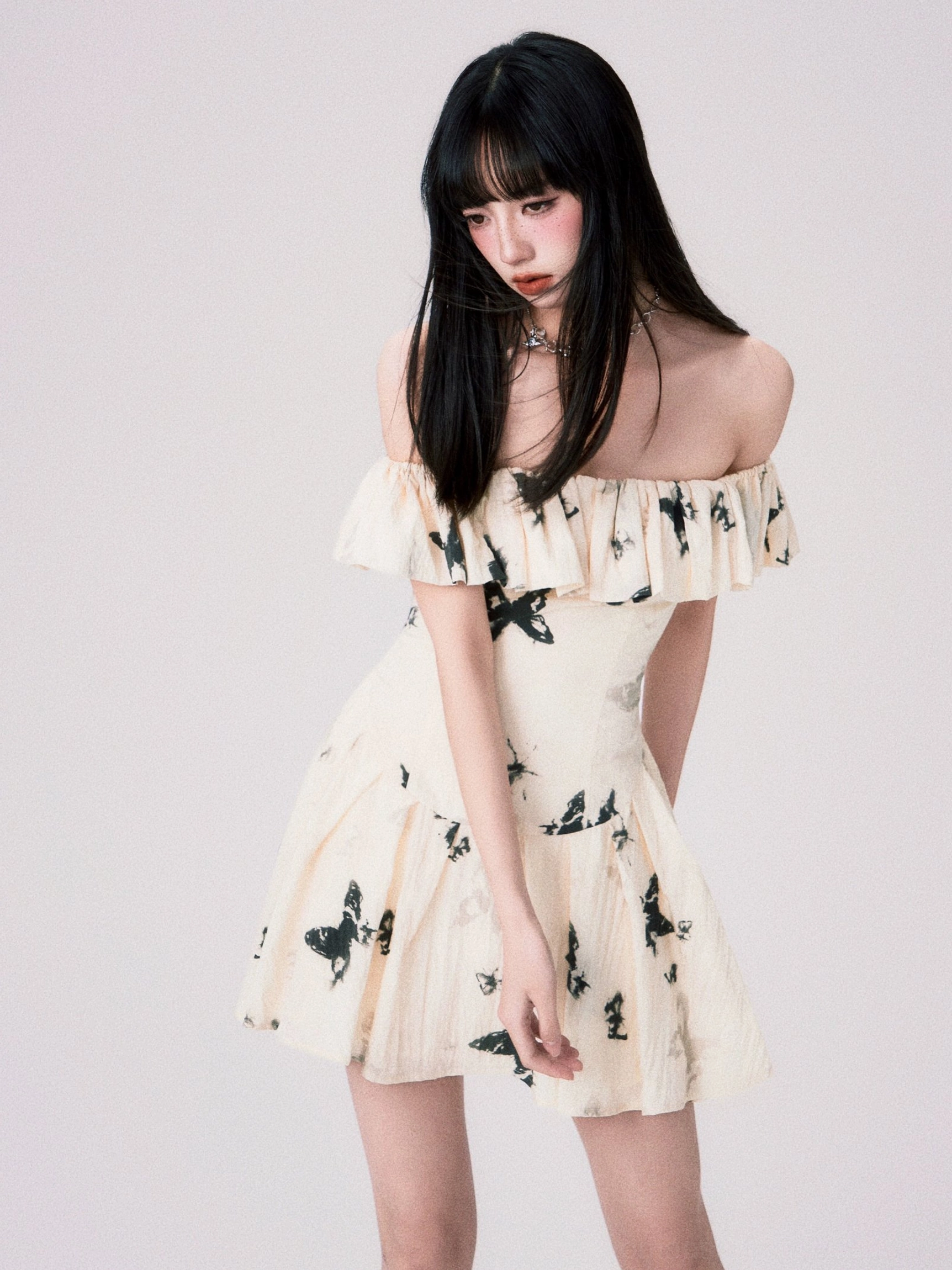 Off-shoulder ruffle neckline and butterfly print dress fashion detail