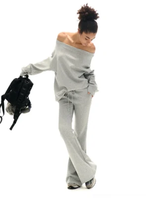 Heather gray off-shoulder sweatshirt and flare sweatpants streetwear separates side view with backpack styling