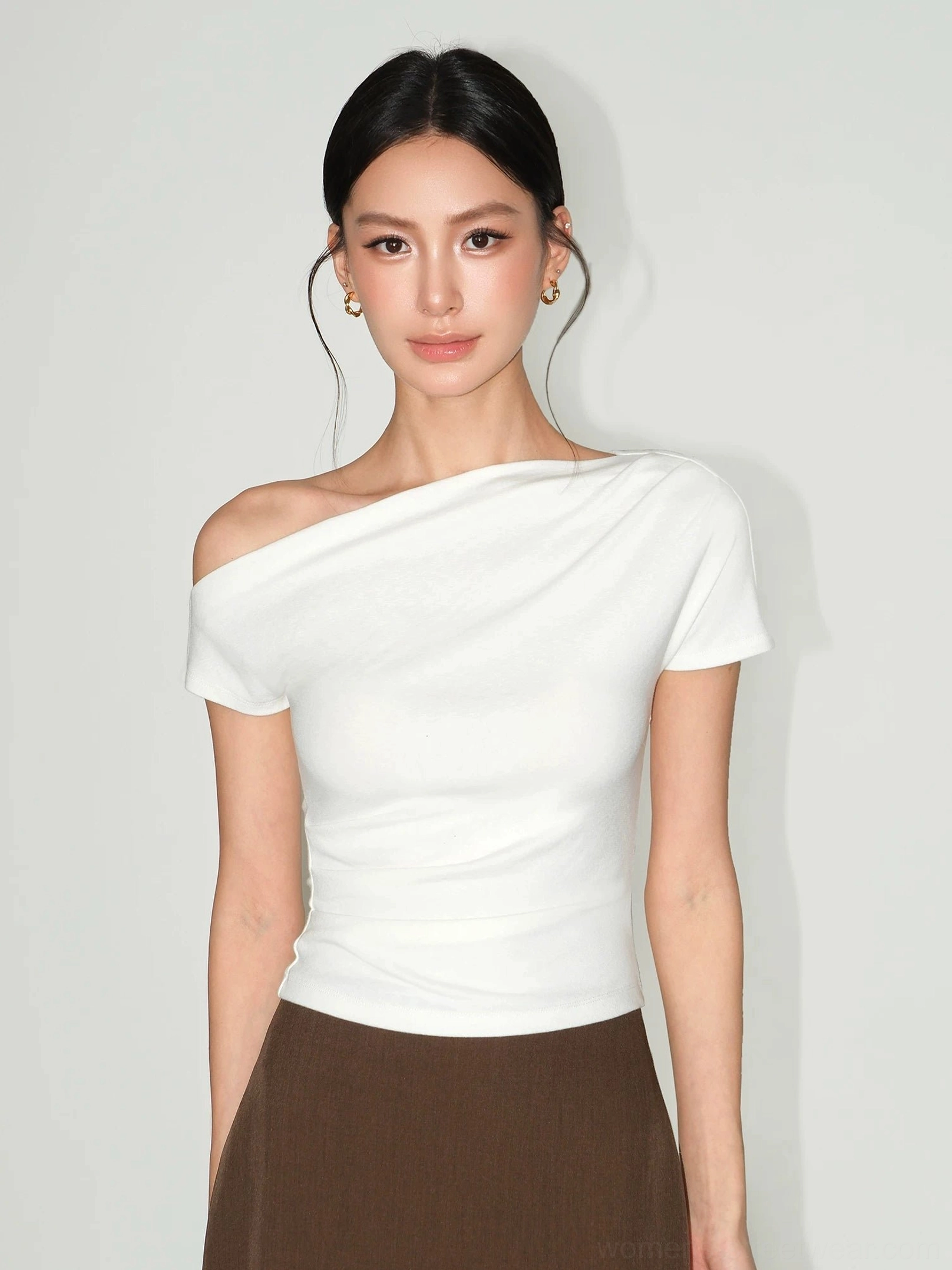 Off-white asymmetric one-shoulder slim-fit T-shirt styled with a brown midi skirt for feminine streetwear