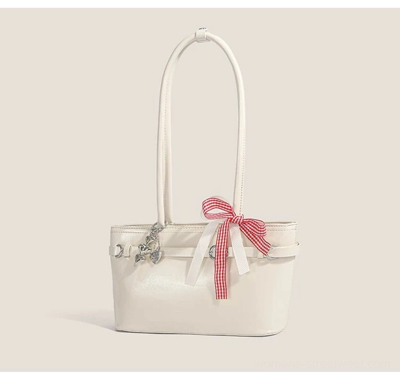 Off-white cherry picnic baguette shoulder bag shown from the front with glossy faux leather body, red gingham ribbon, zipper closure, and silver hardware