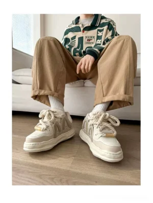 Off-white chunky platform sneakers styled with khaki pants and white socks, showing a minimalist Korean streetwear outfit and elevated thick sole
