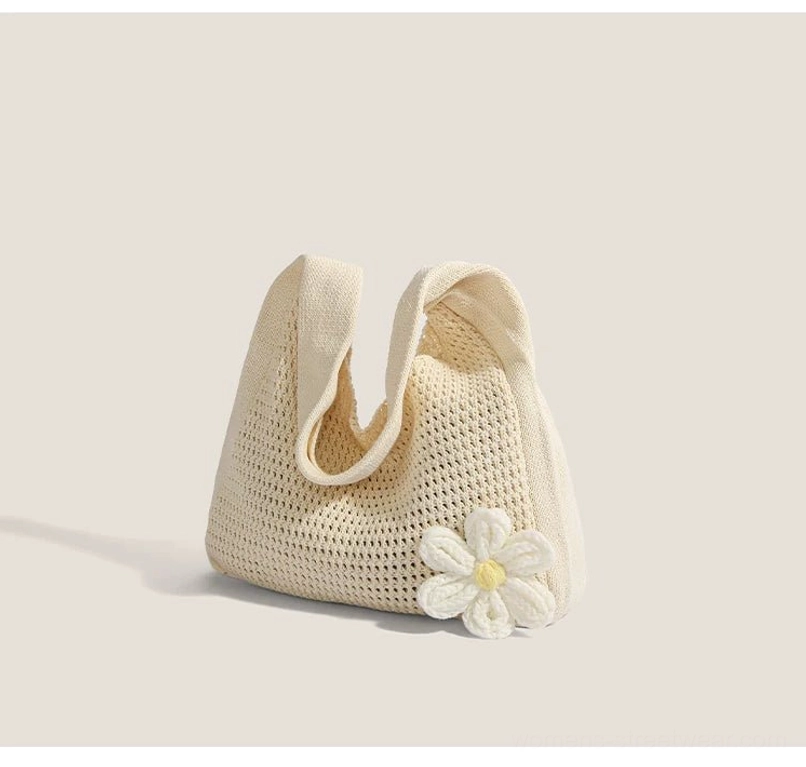 Off white crochet hobo shoulder bag shown from a low angle with open weave and 3d flower decoration