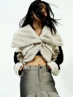 Off white cropped faux fur collar aviator jacket with black colorblock sleeves shown in a front three quarter studio outfit view