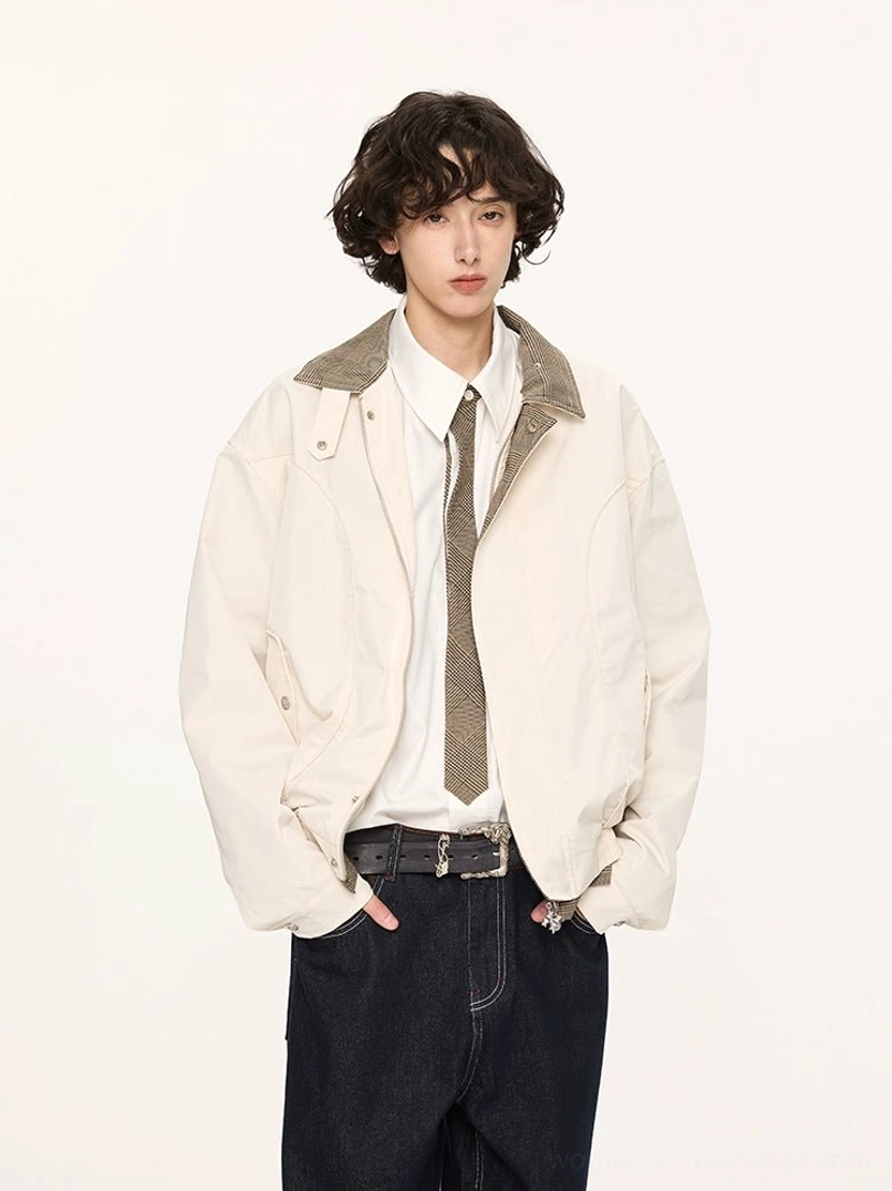 Male model wearing an off-white cropped Harrington jacket with contrast grey collar and cuffs white shirt tie and dark denim