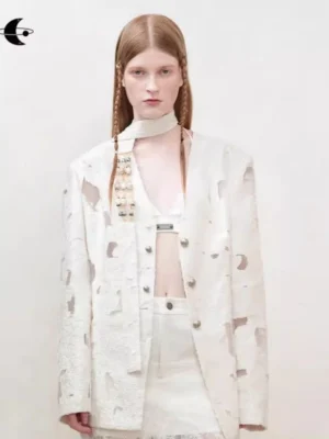 Off-white distressed cutout blazer for women styled with a cropped inner set in a minimalist studio front view