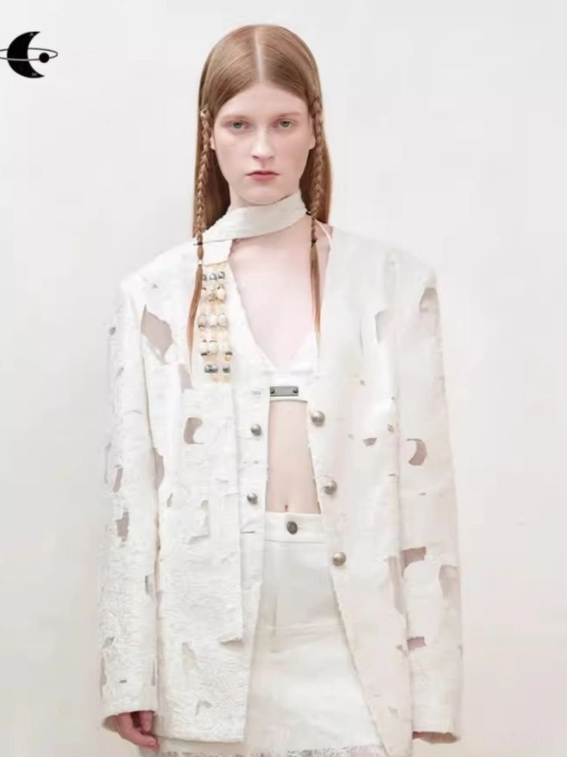 Off-white distressed cutout blazer for women styled with a cropped inner set in a minimalist studio front view