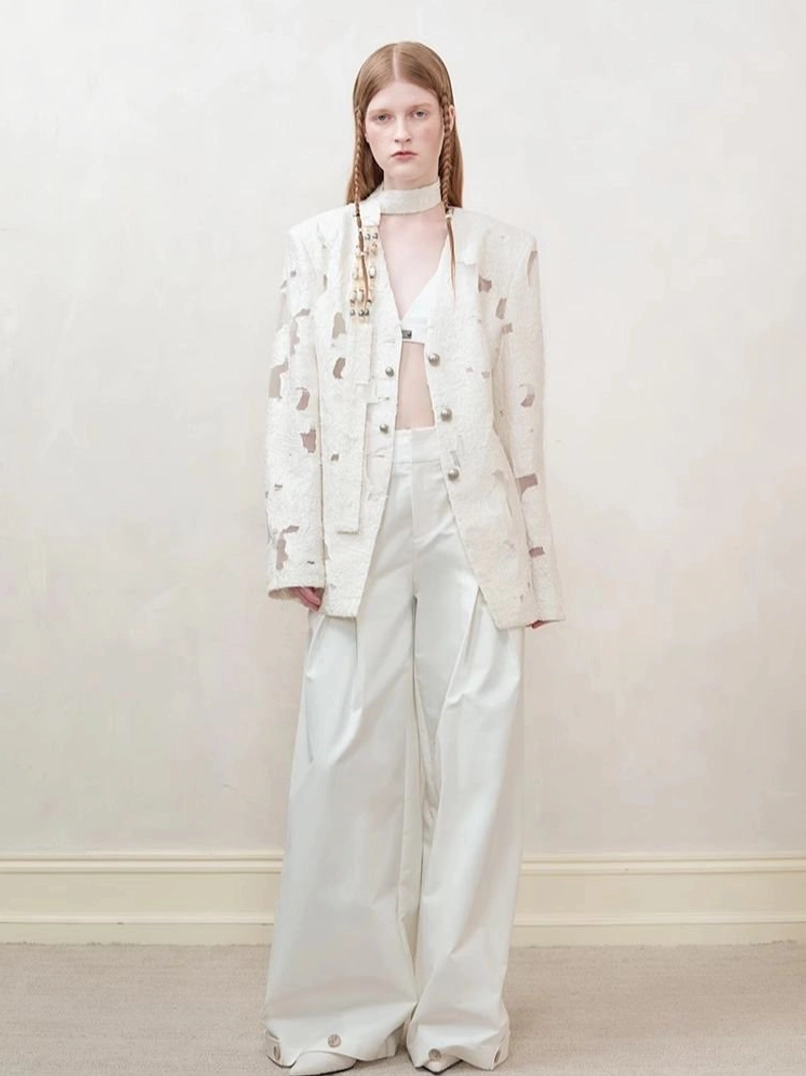 Off-white distressed cutout women’s blazer showing deconstructed perforated streetwear design