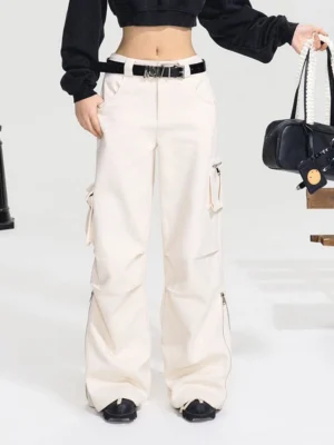 Off-white high-waist wide-leg cargo pants with side utility pockets and zippered hems styled in streetwear outfit