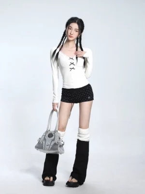 Off-white lace trim V-neck bow knit sweater styled with polka dot shorts leg warmers platform sandals and a gray handbag