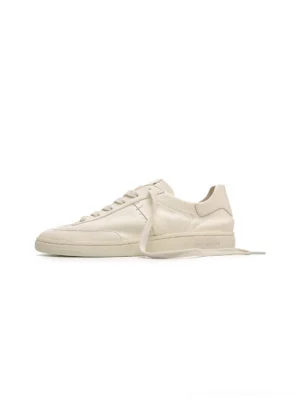 Off-white low-profile cowhide leather sneakers shown in side profile with a minimalist flat streetwear silhouette and clean lace-up design