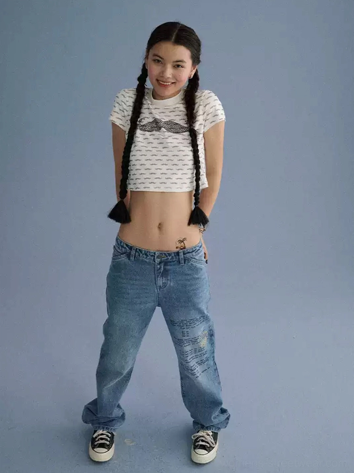 Off-white mustache graphic cropped tee with subtle all-over line pattern and navel-baring Y2K silhouette