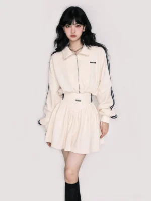 Off-white navy cropped track jacket and high-waisted pleated mini skirt front full-body view