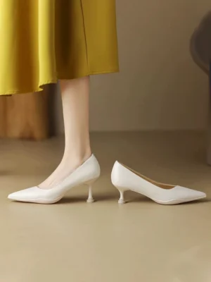 Off-White pointed-toe kitten heel pumps in polished leather styled with a mustard yellow midi skirt