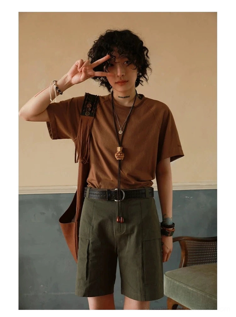 Off-white raglan crew neck t-shirt styling shot with minimalist accessories and layered casual aesthetic