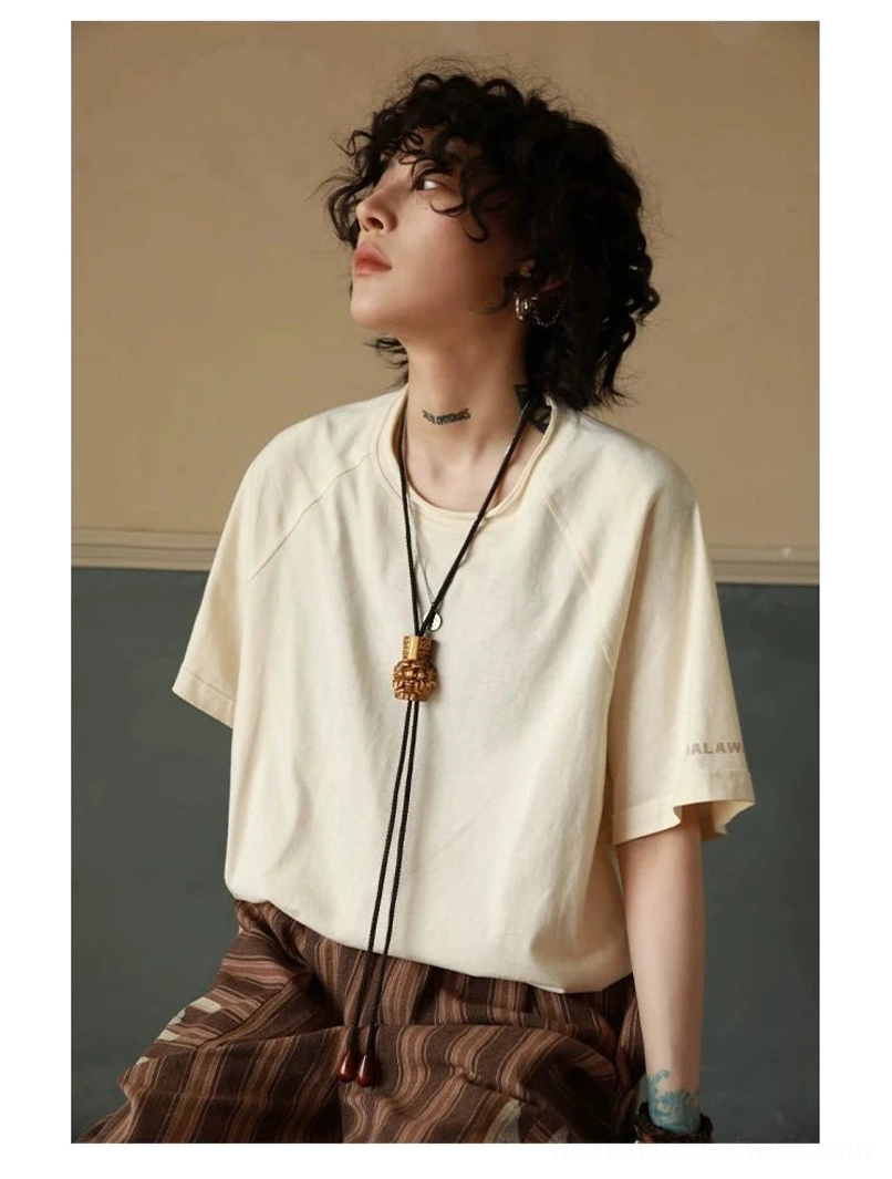 Off-white raglan sleeve t-shirt showcasing raw edge sleeve detail and double-layered collar construction closeup