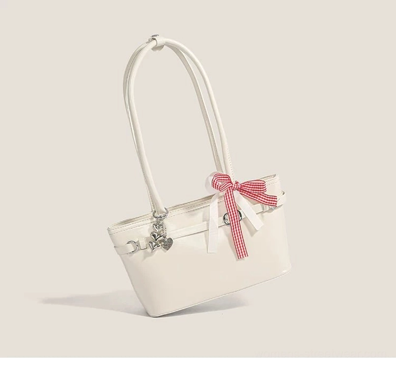 Off-white ribbon bow baguette shoulder bag displayed at an angle with red gingham scarf detail, silver hardware, and glossy faux leather finish