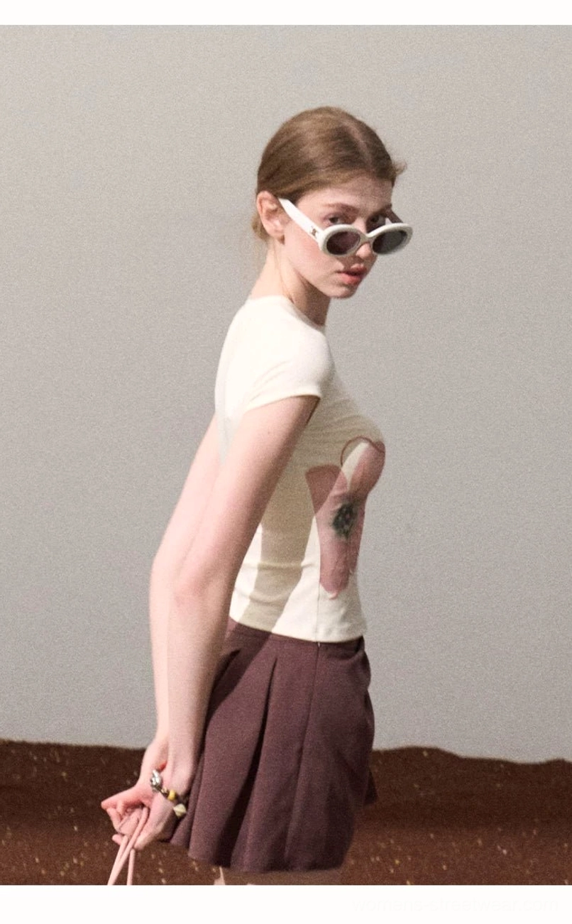 Off-white fitted cropped tee with delicate rose graphic styled with a dark brown pleated mini skirt