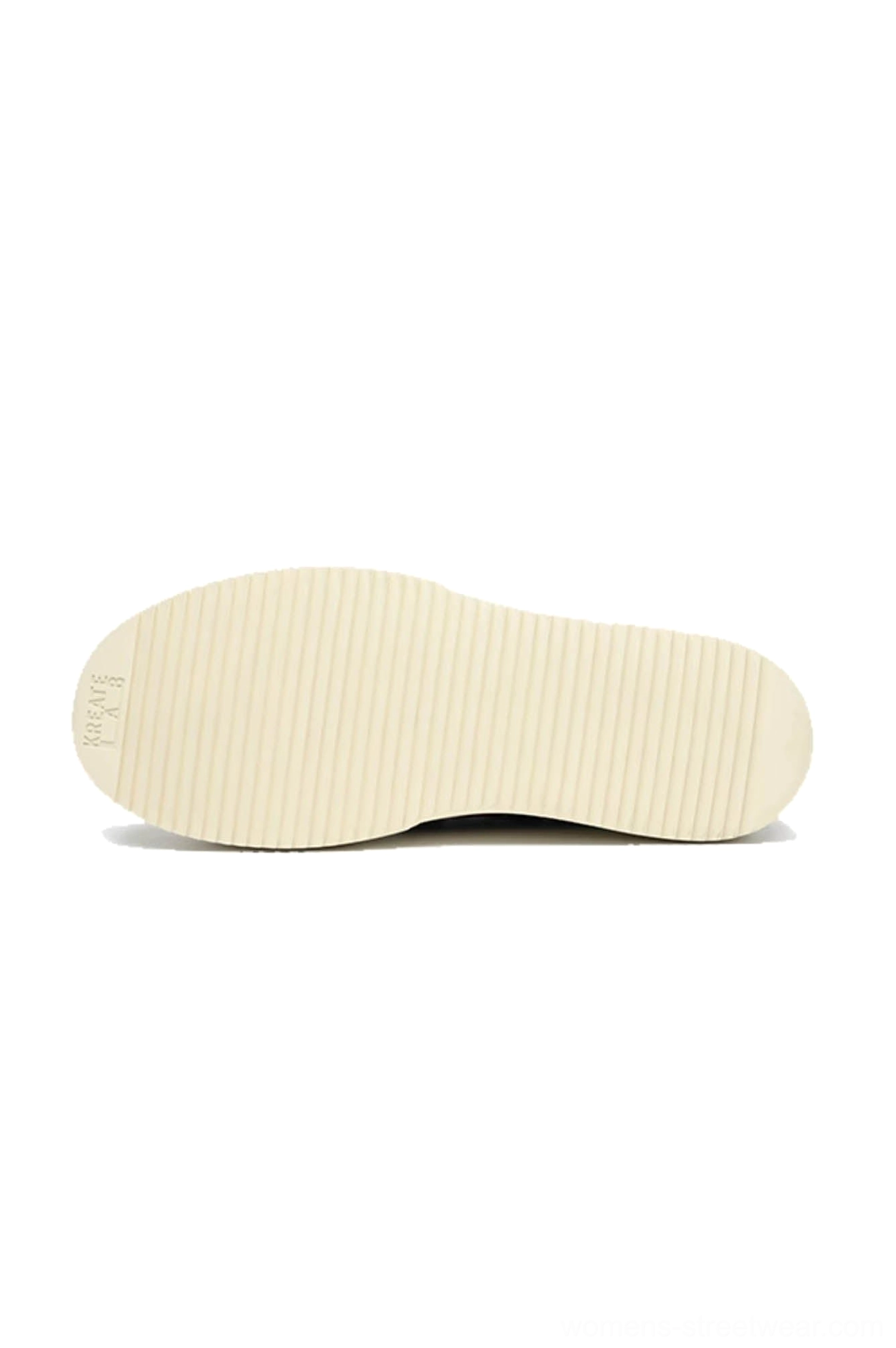 Off-white rubber outsole of low-top platform sneakers showing horizontal striped anti-slip tread pattern