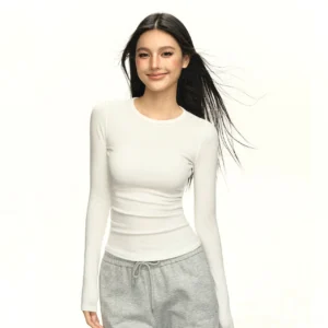 Off white sculpted ribbed crew neck long sleeve top with thumbhole cuffs on model