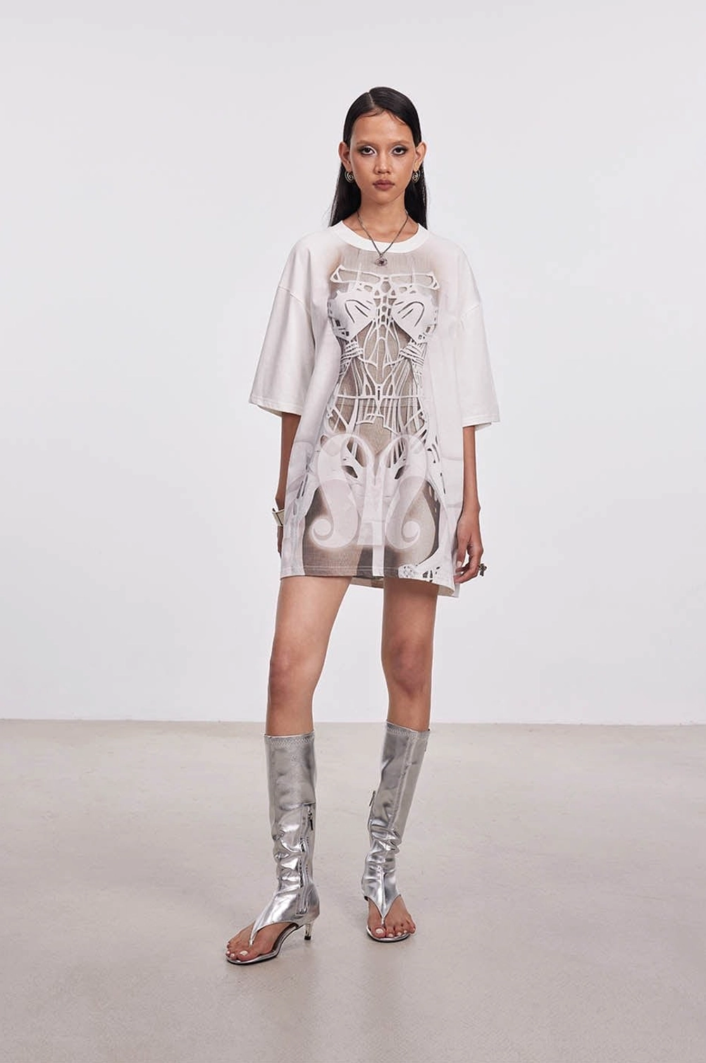 Front full-body view of a loose off-white skeleton print tee dress with crew neck and short drop shoulder sleeves