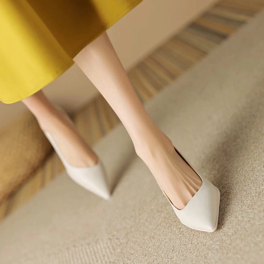 Off-White soft leather pointed-toe pumps with tapered kitten heel shown from the side