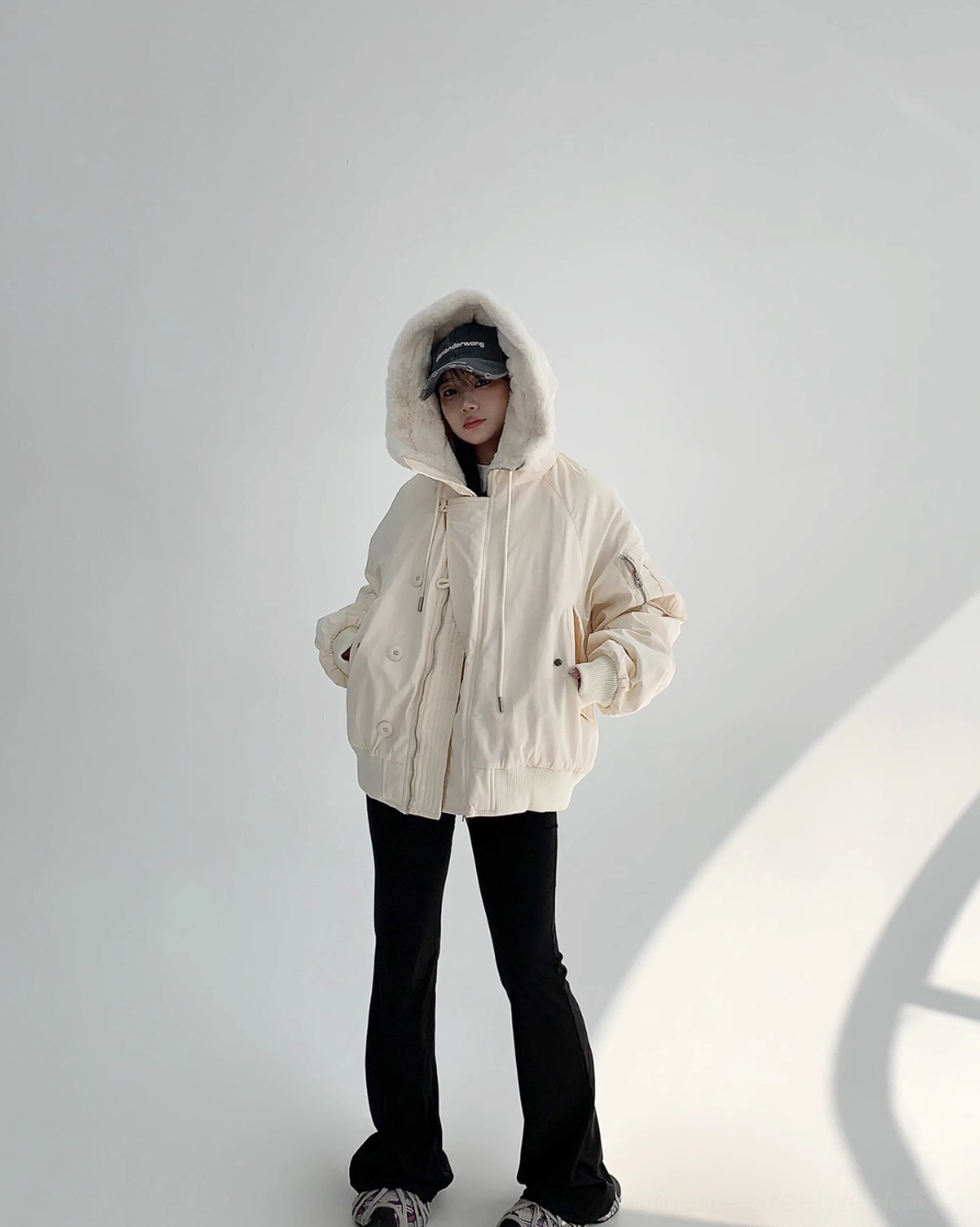Off-white streetwear bomber jacket with plush faux-fur lining, oversized hood, ribbed cuffs, and warm winter design