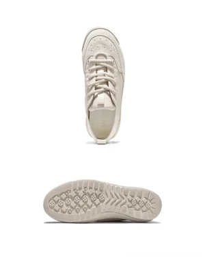 Off-white textile and suede low-top streetwear sneakers shown from the side with lace-up closure and fabric heel pull tab