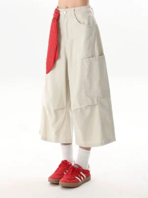 Off-white wide-leg cropped cargo culottes with red striped tie accent shown in a front left studio view