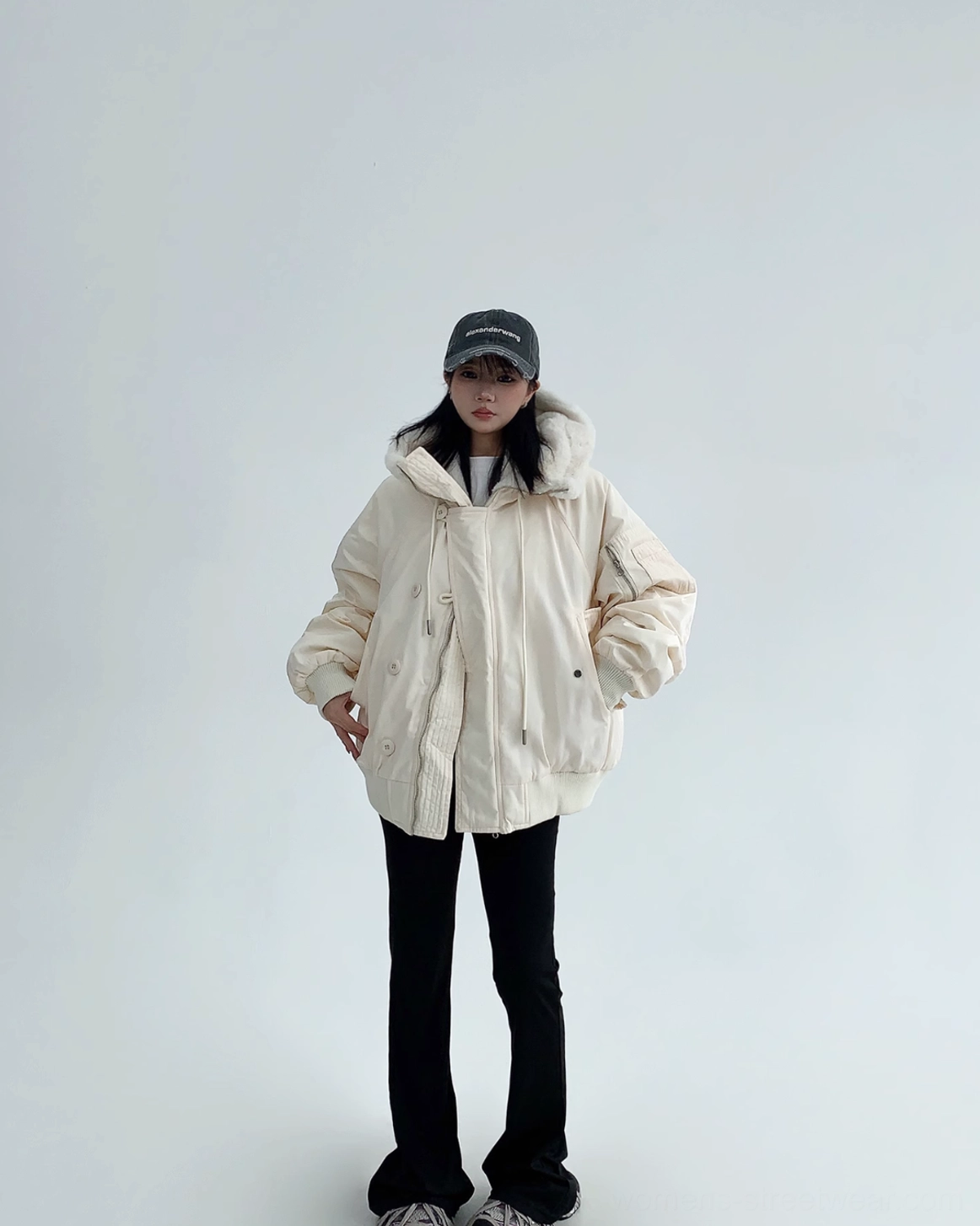 Off-white oversized winter bomber jacket featuring a soft sherpa lining, padded sleeves, and a structured button front