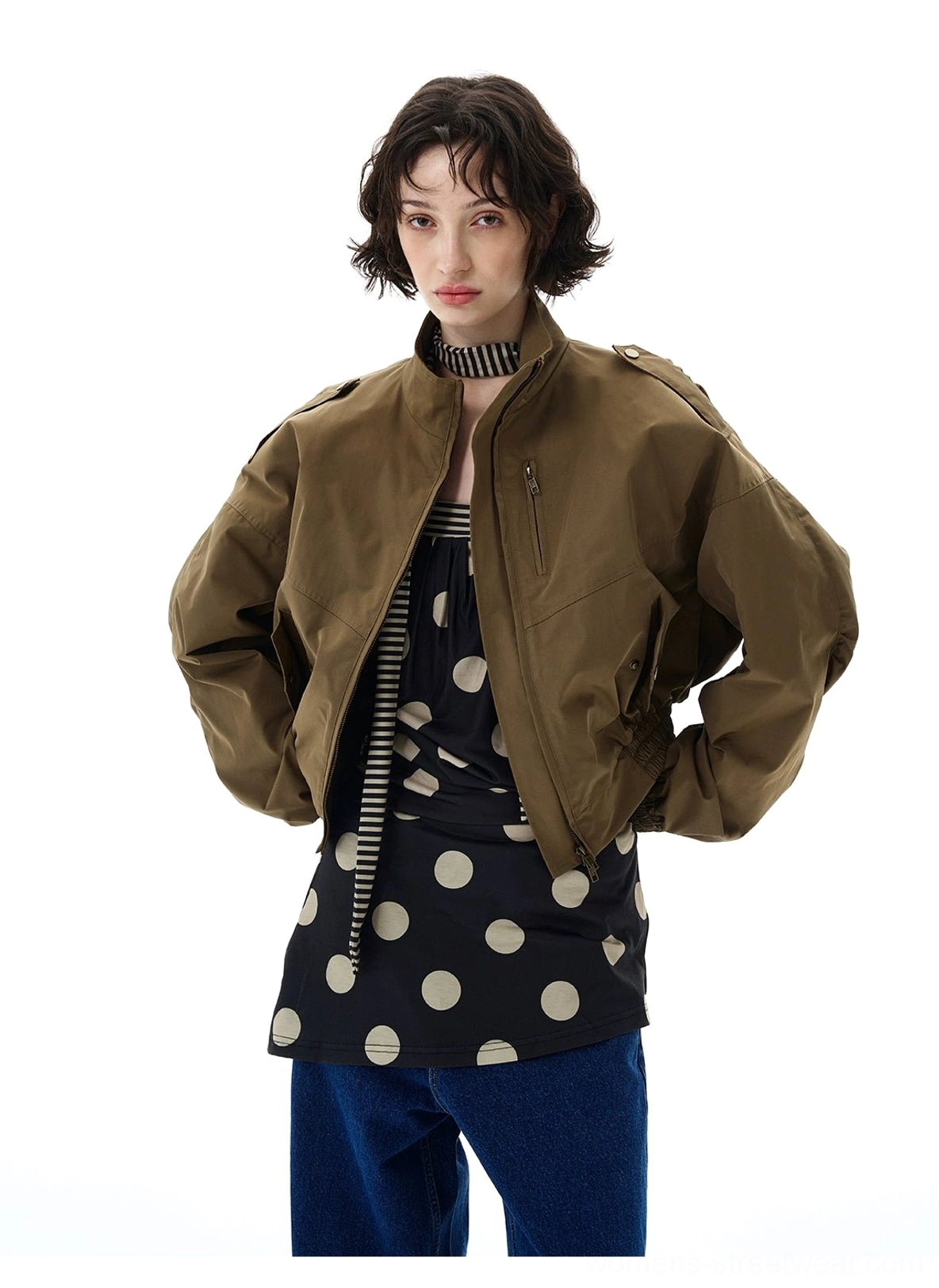 Olive army green cropped bomber jacket with functional utility pockets, relaxed sleeves, and contemporary streetwear silhouette