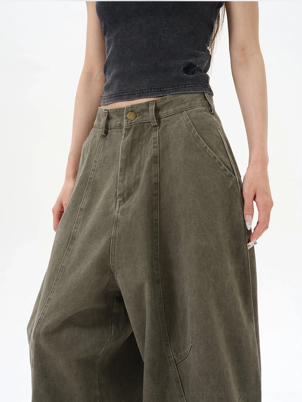 Close-up of olive cargo pants waistband with metal button fly belt loops and curved utility pocket stitching
