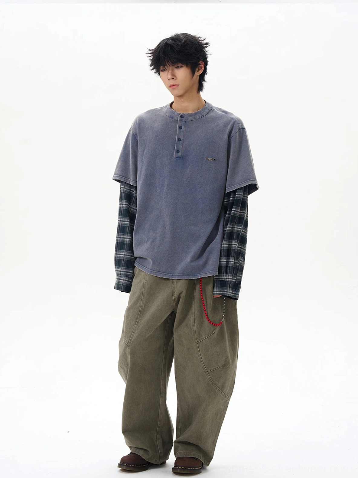 Olive wide-leg cargo pants with red chain accent and functional side cargo pockets on a layered streetwear outfit
