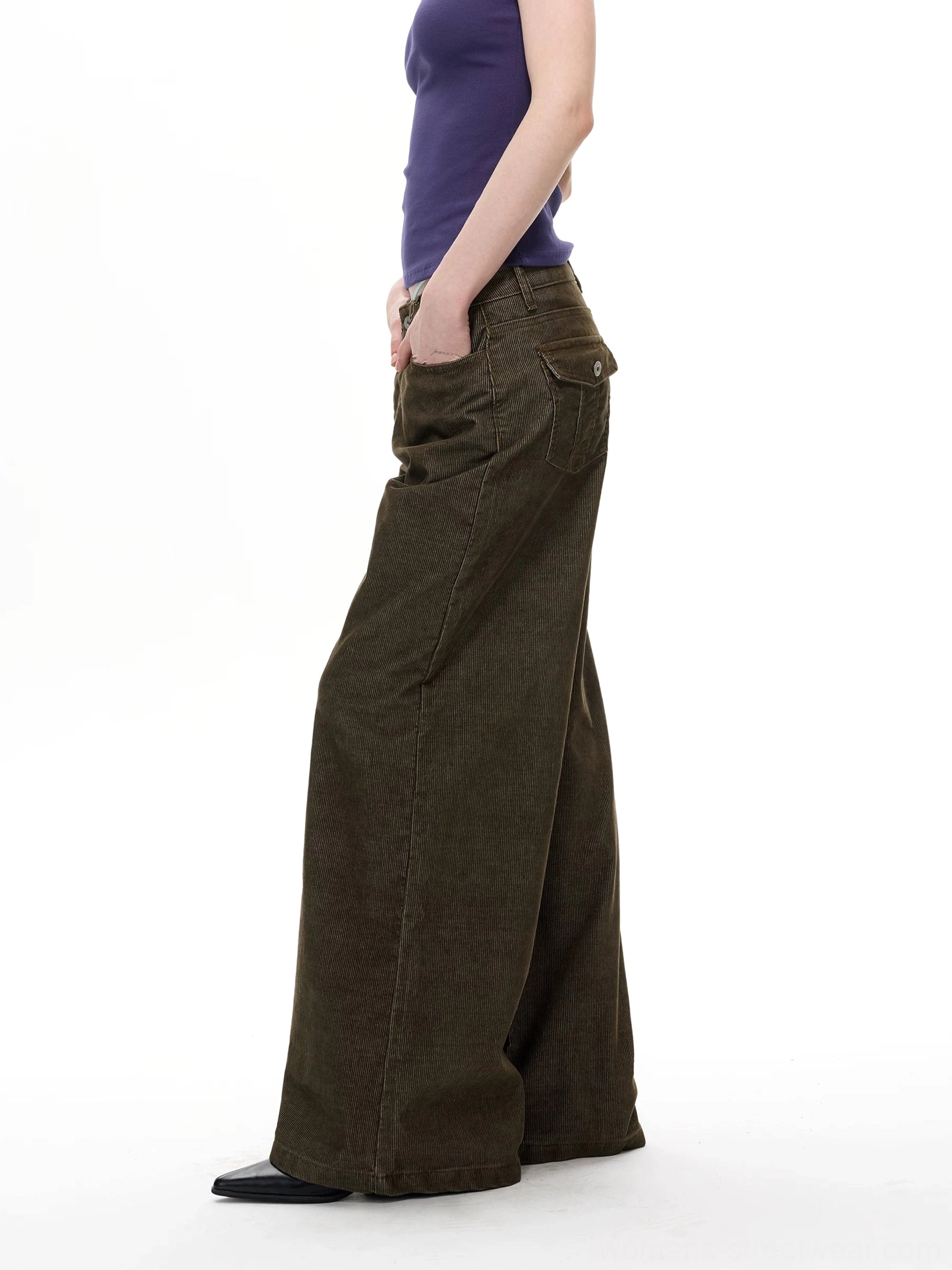 Side view of olive corduroy wide leg streetwear pants showing relaxed floor length leg and rear pocket detail