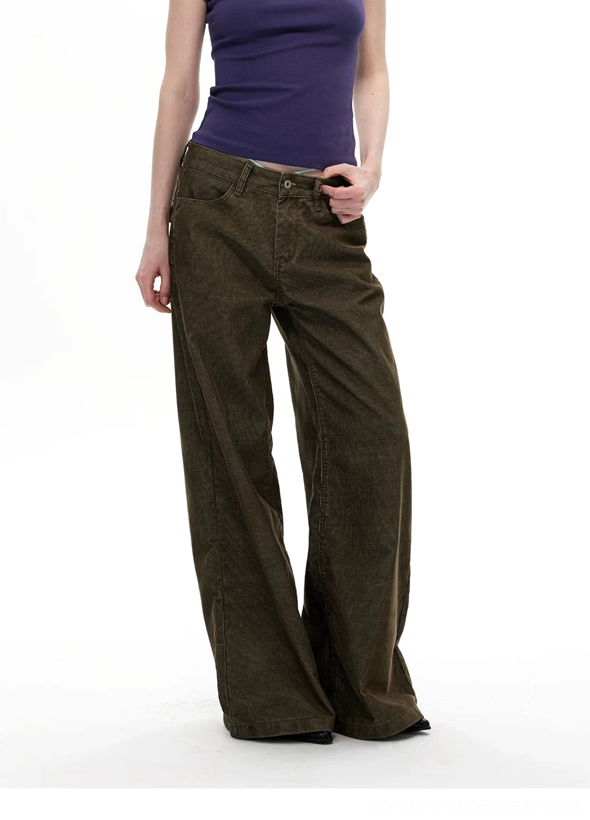 Three quarter front view of olive corduroy wide leg streetwear pants with button fly waistband and front pocket