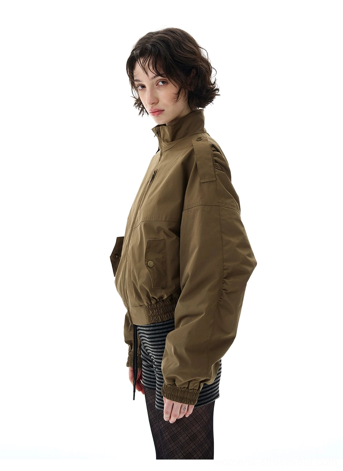 Close side view of olive green cropped utility jacket with stand collar, shoulder epaulets, side snap pocket, and relaxed fit