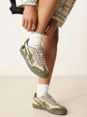 Unisex olive and cyan green retro sneakers worn with white frilled crew socks in a Korean streetwear styling view