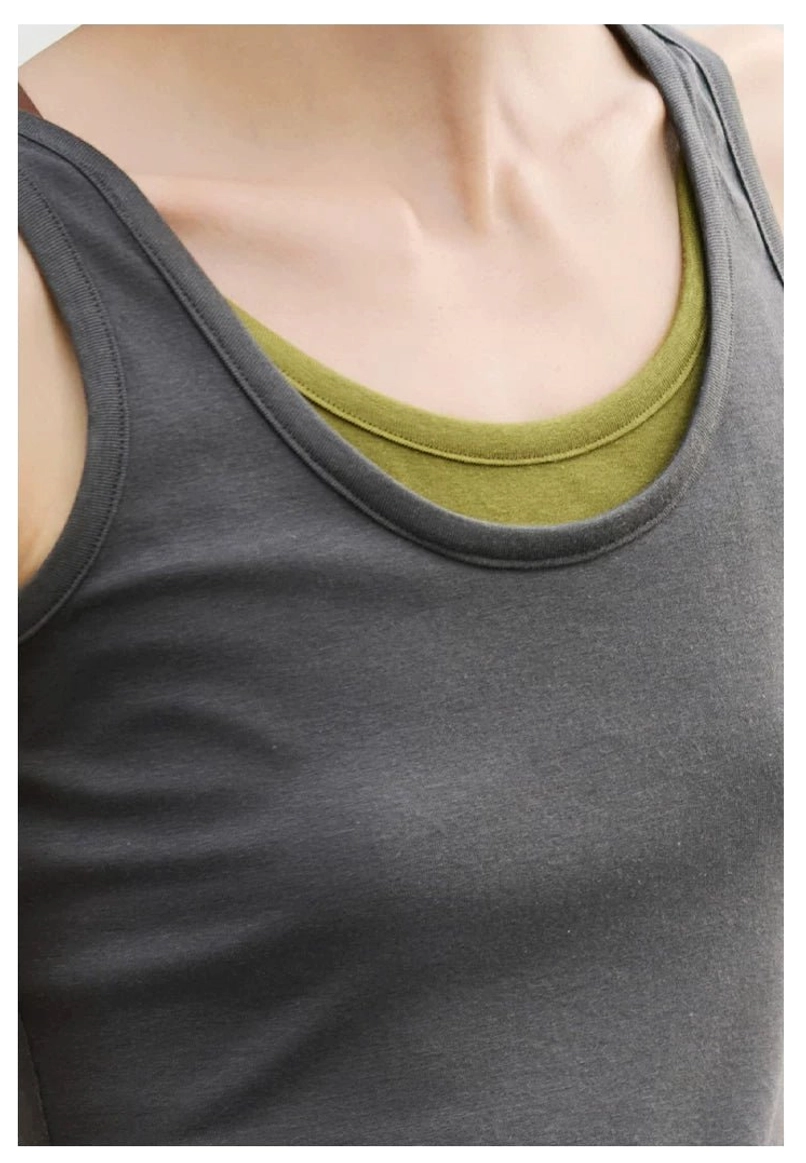 Detailed close-up of olive green inner layer and dark gray outer scoop neckline on stretch knit tank top