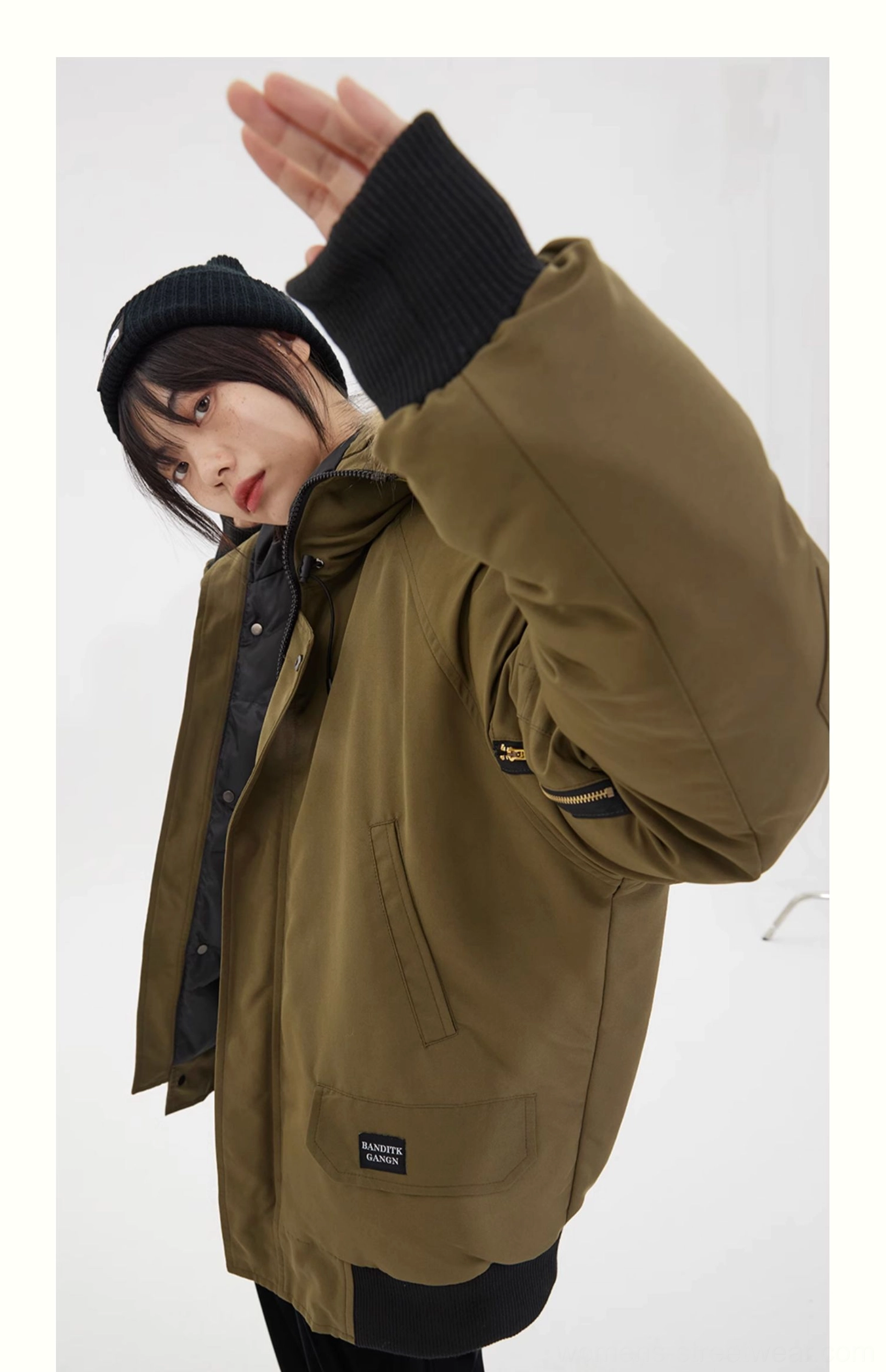 Side rear view of an olive green oversized faux fur hooded parka with zip front flap pockets and ribbed knit cuffs