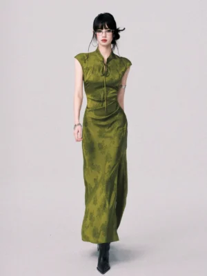 Olive green qipao inspired satin jacquard maxi dress with cap sleeves fitted waist collar tie and black ankle boots