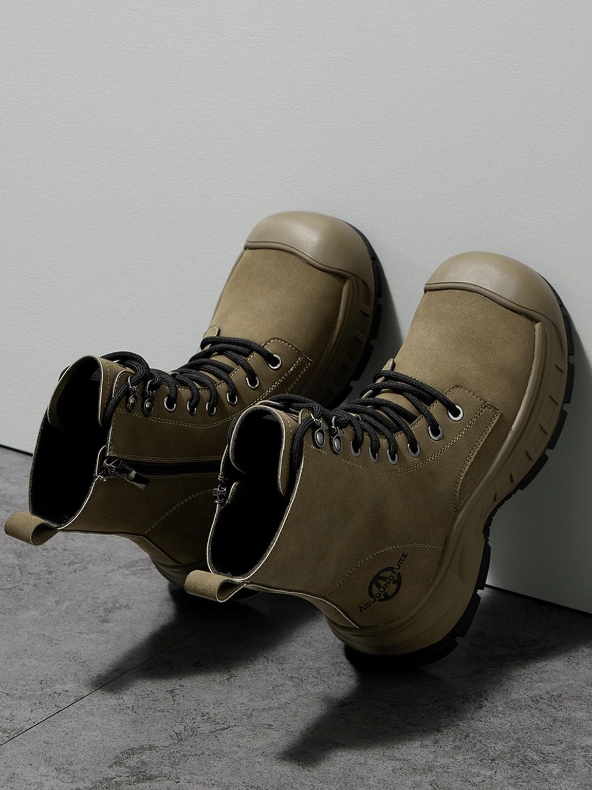 Overhead view of olive green lace-up platform combat boots with zipper and reinforced toe details