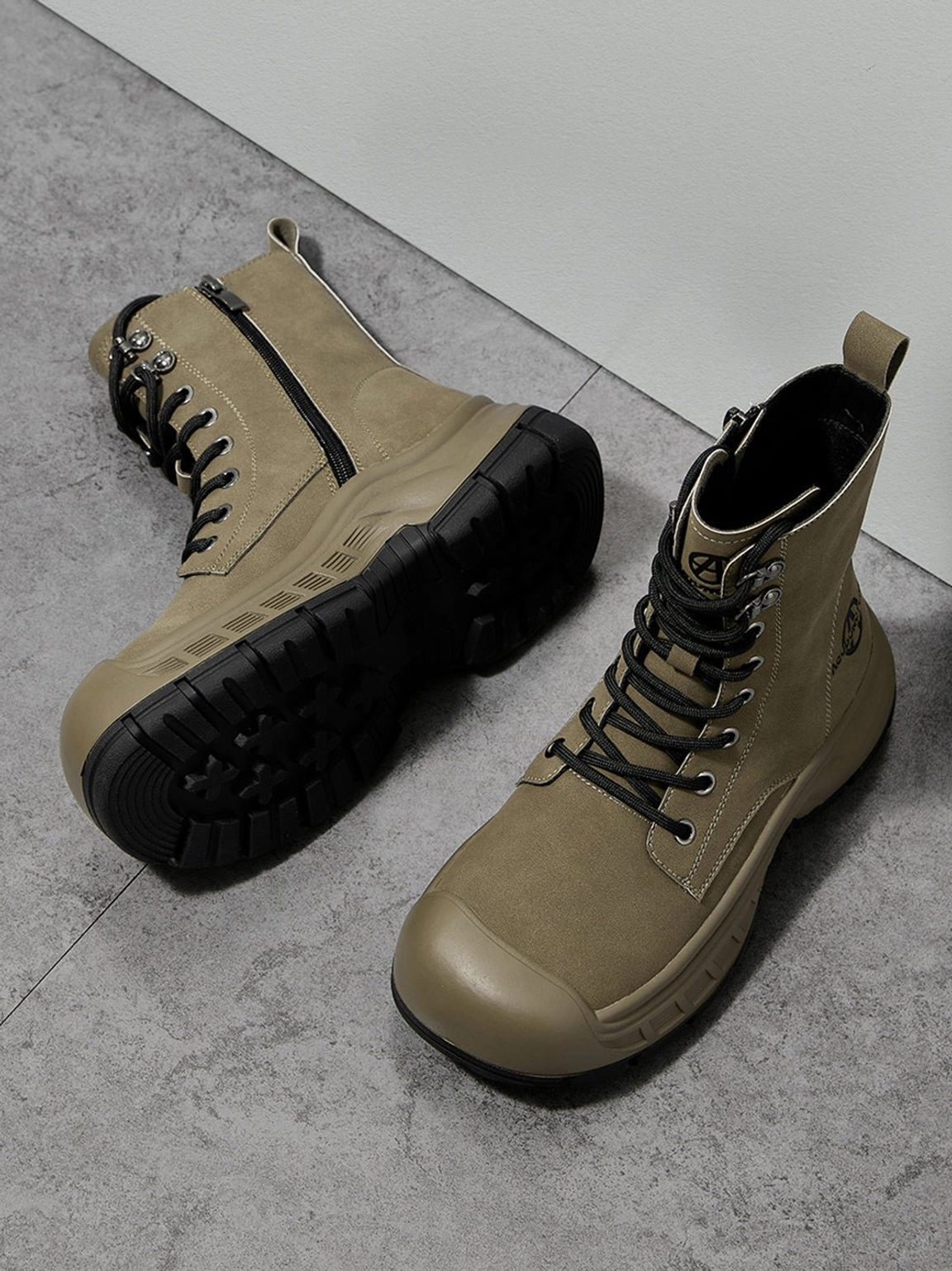 Low angle view of olive green reinforced toe combat boots with rugged platform rubber outsoles